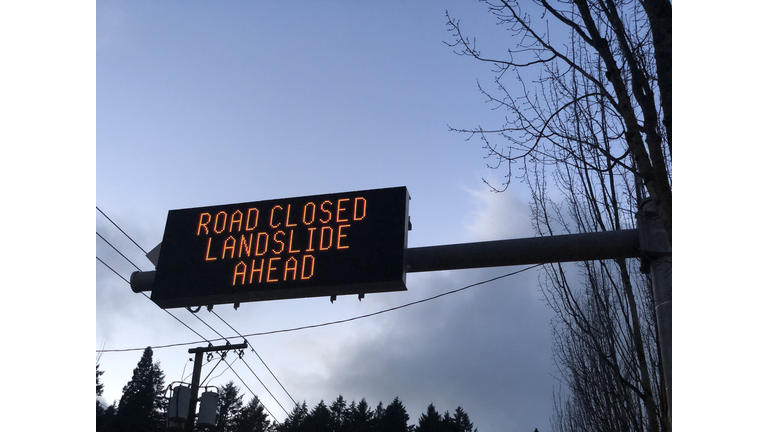 A road sign alerting drivers of a landslide ahead.