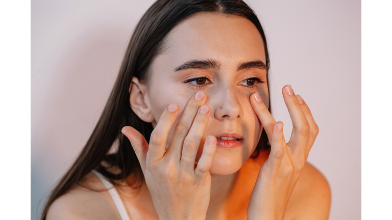 Woman applying eye cream