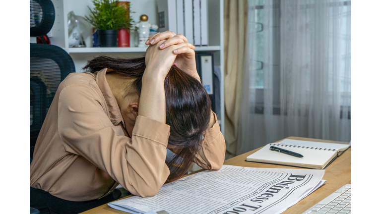 Woman's head is down on the table. Frustrated and Exhausted working. Disappointed