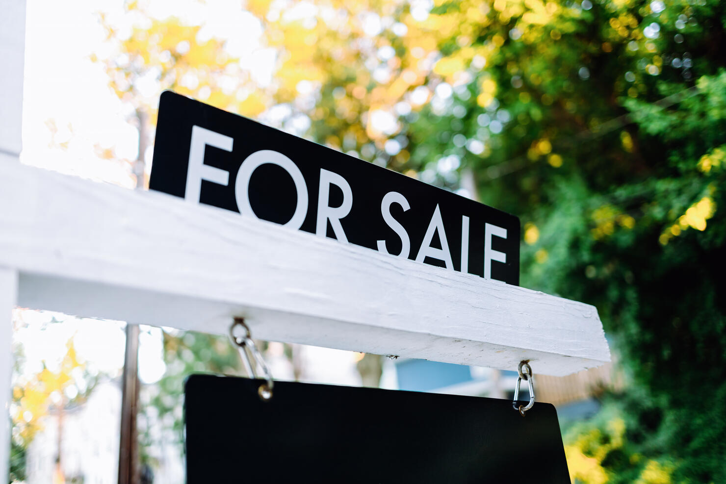 For Sale Sign in Front Yard of House