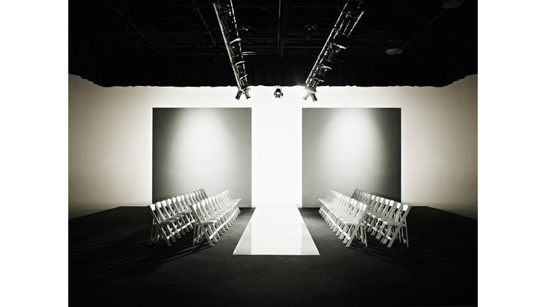 Chairs around catwalk set for fashion show