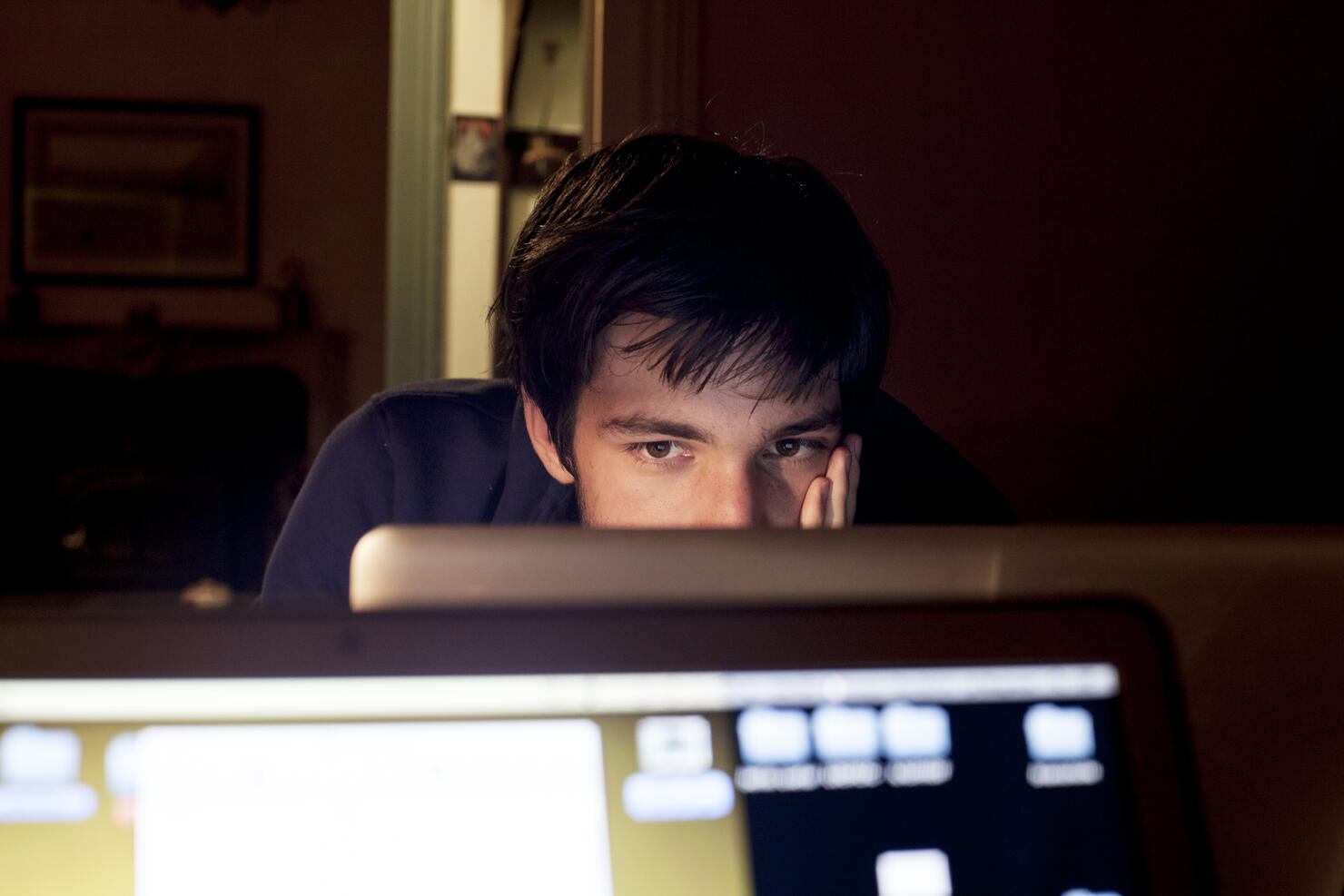 Adolescent staring at computer screen
