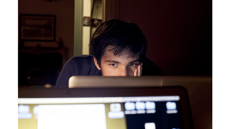 Adolescent staring at computer screen