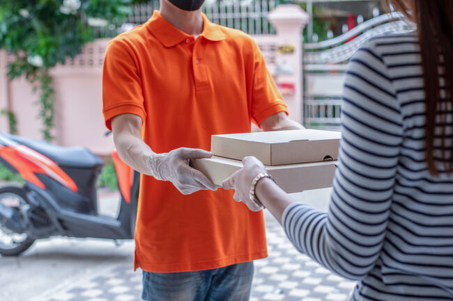 Young handsome man delivering pizza