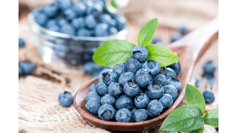 Heap of fresh Blueberries on a Wooden Spoon close-up shot,Romania