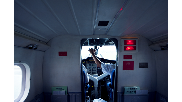 A pilot in the cockpit controls the planes acceleration in take-off.
