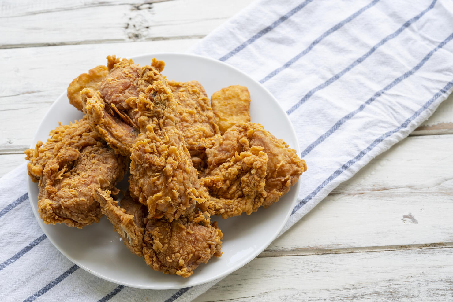 White Plate of Fried Chicken on Wood Table