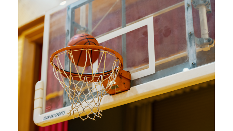 Basketball going into a basketball hoop