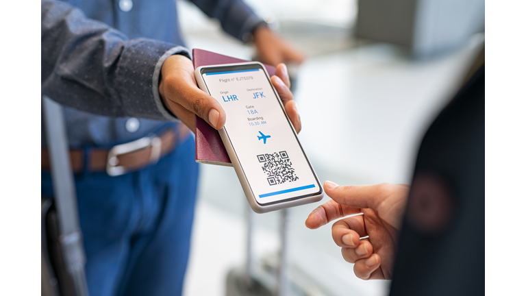 Man showing health vaccination passport to stewardess before flight