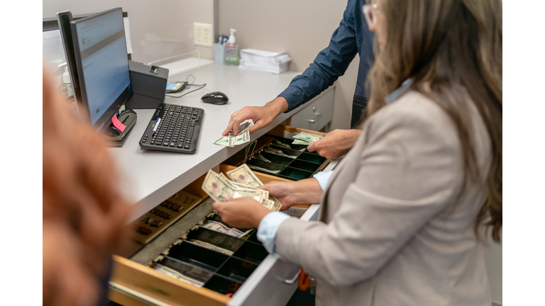 Bank teller counting money