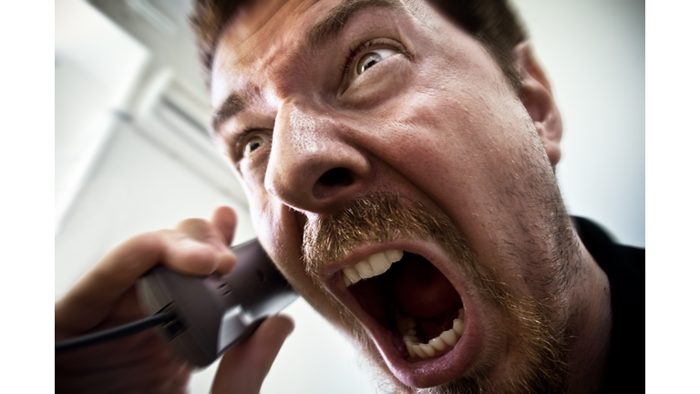 Man shouting at telephone