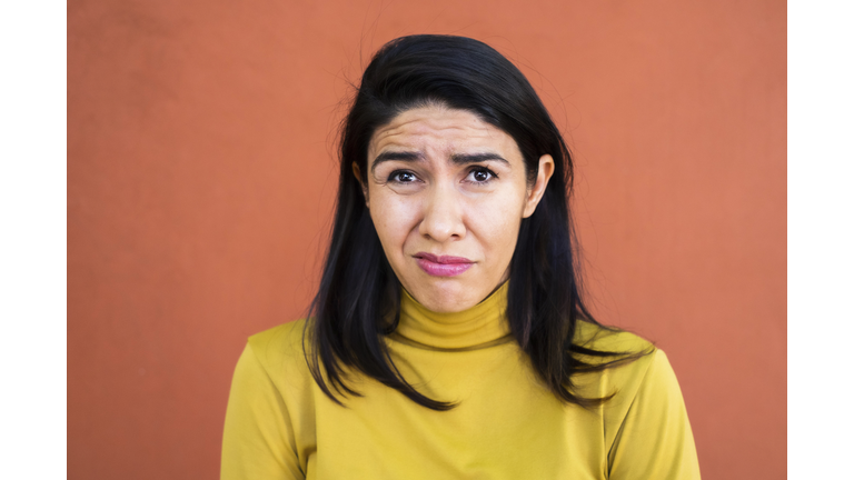 Latino woman making a face looking uncertain, confused, perplexed, WTF