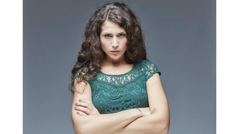 Portrait of angry young woman with crossed arms