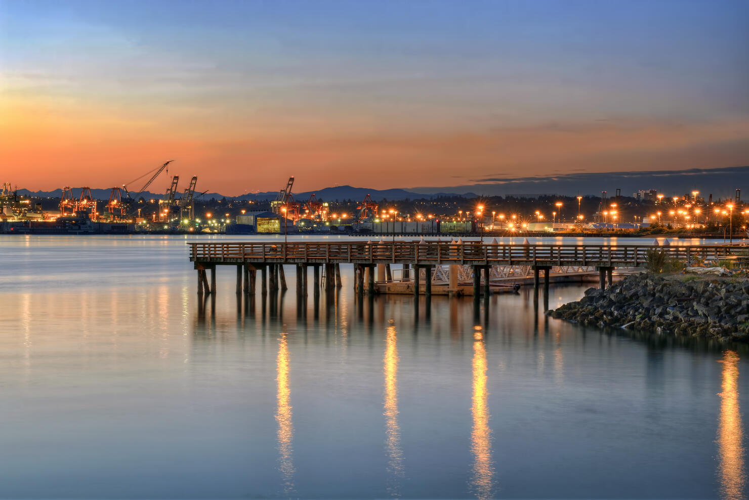 Illuminated harbor and pier at sunset, Alki Beach, Seacrest Park, Seattle, Washington, USA