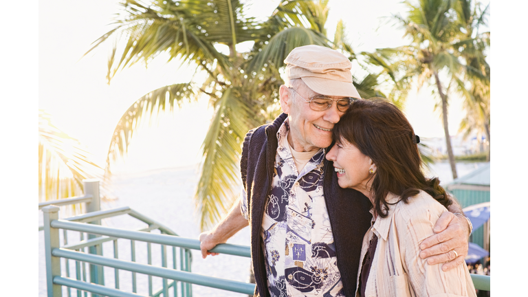 Older couple hugging outdoors