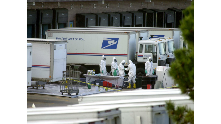 Workers in protective suits prepare to t