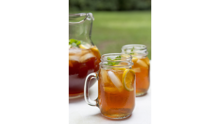 Iced Tea in Pitcher and Glass Mugs with Lemon and Mint