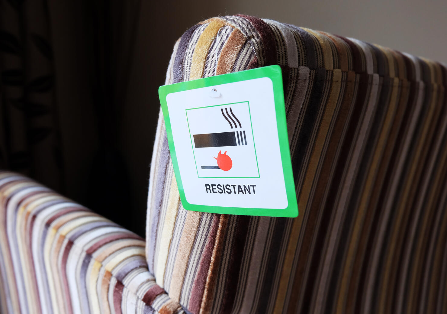 Flame resistant label attached to furniture