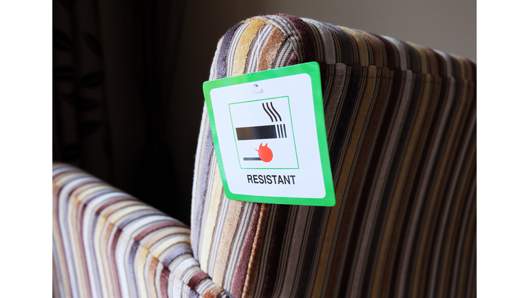 Flame resistant label attached to furniture