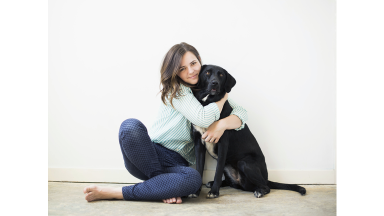 Portrait of woman with black dog