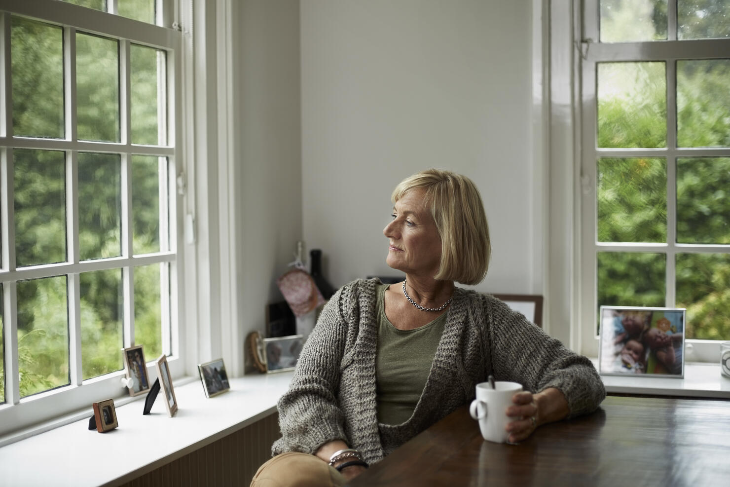 Thoughtful senior woman having coffee