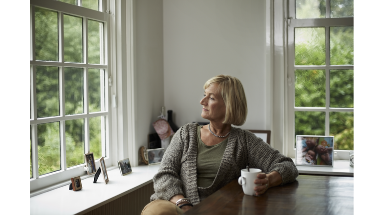 Thoughtful senior woman having coffee