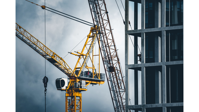 Construction tower cranes on a building site