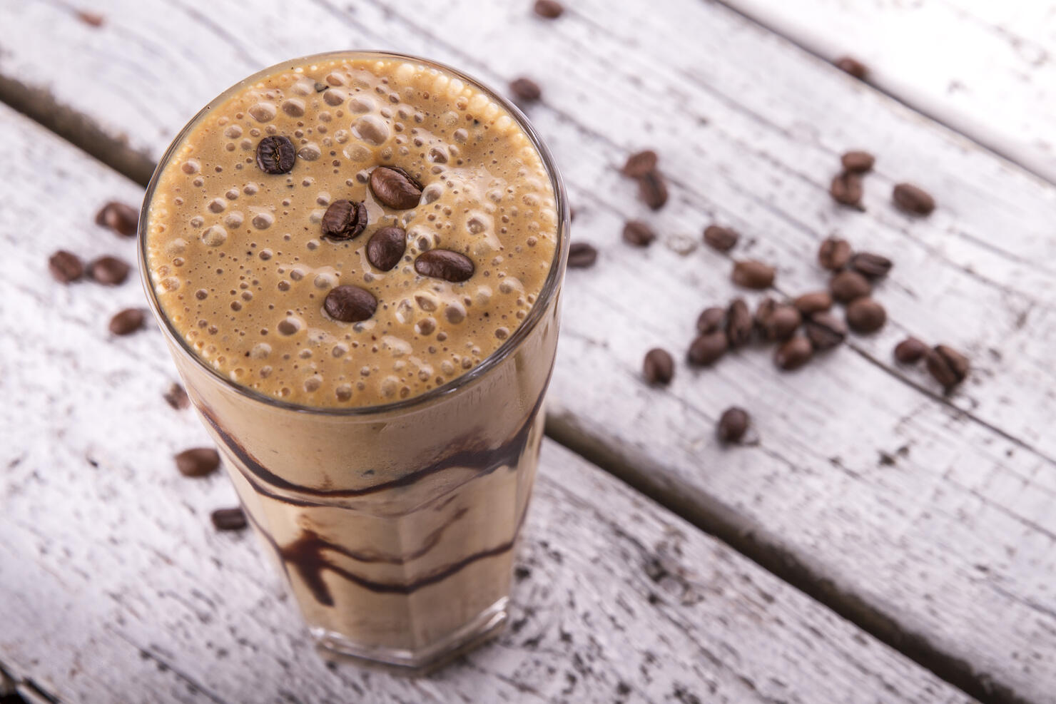 Cold chocolate milkshake frappe in tall glass with ice