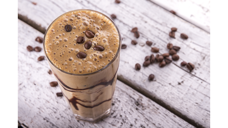 Cold chocolate milkshake frappe in tall glass with ice