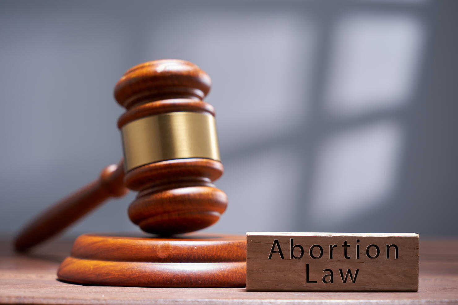 gavel hammer and wood block with text abortion law