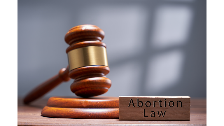 gavel hammer and wood block with text abortion law