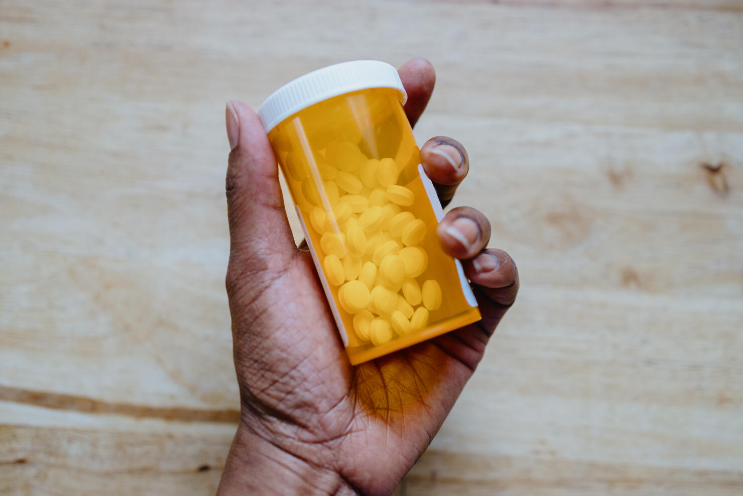 Woman Holds Bottle of Prescription Medication