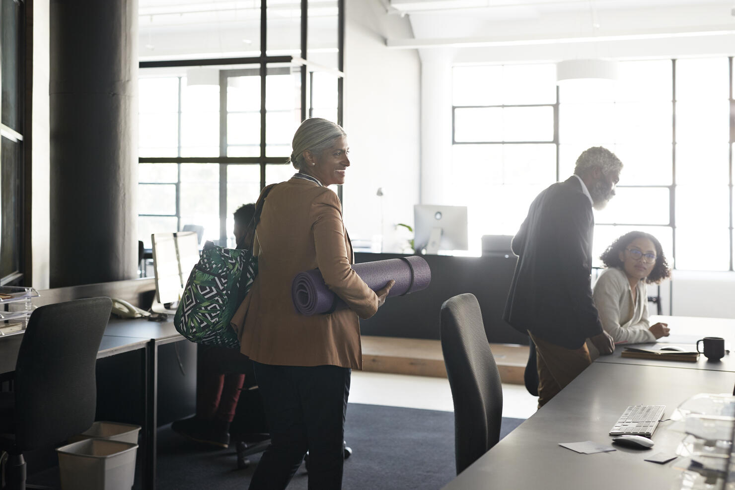 Businesswoman with coworkers at modern workplace