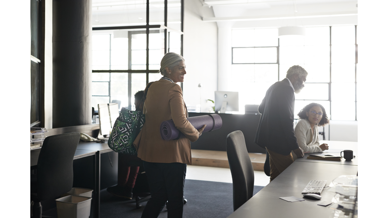 Businesswoman with coworkers at modern workplace