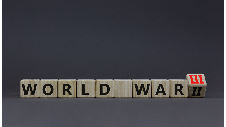 WW3 world war 3 symbol. Turned the wooden cube and changed the concept word World War 2 to World War 3. Beautiful grey table grey background, copy space. Business WW3 world war 3 concept.