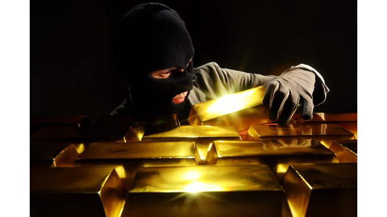 Thief stealing gold bars