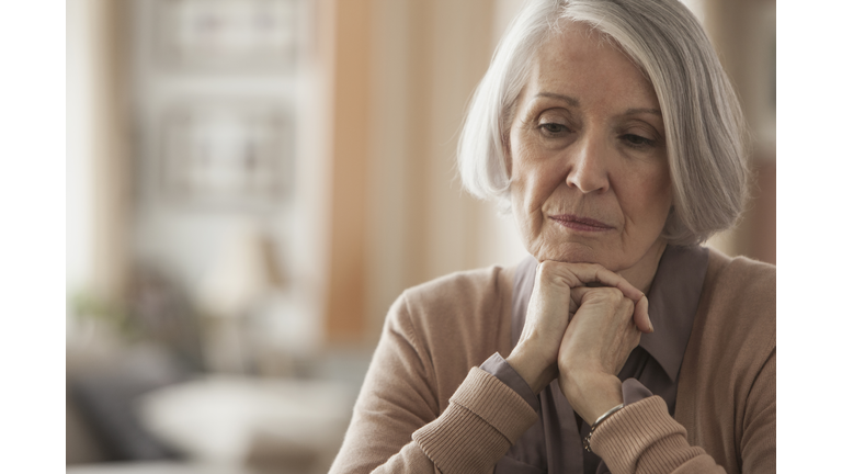 Senior Caucasian woman with chin in hands