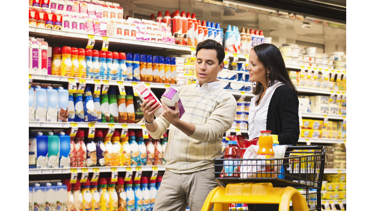 Hispanic couple shopping in grocery store