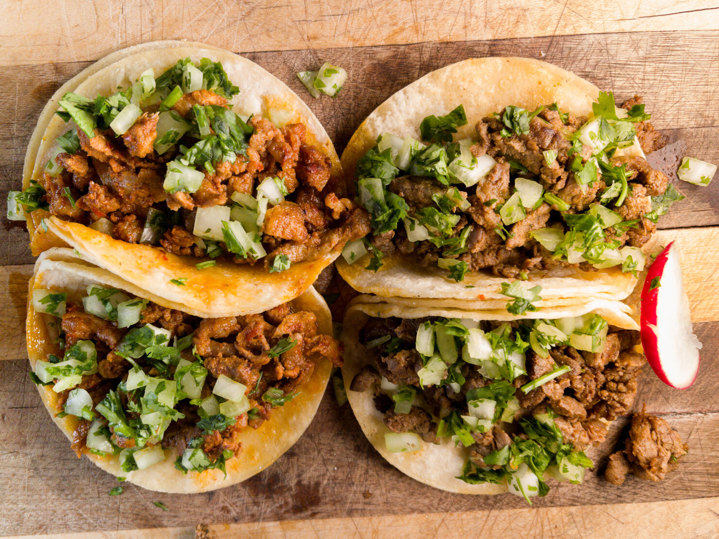 Pork Carnitas Street Tacos Garnished with Jalapeño limes and, salsa