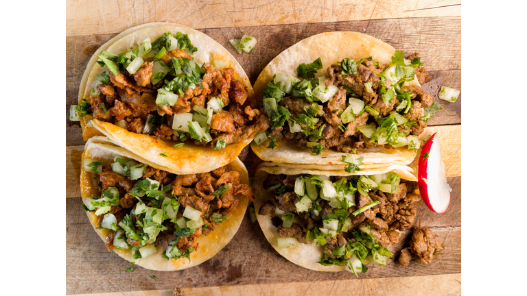 Pork Carnitas Street Tacos Garnished with Jalapeño limes and, salsa