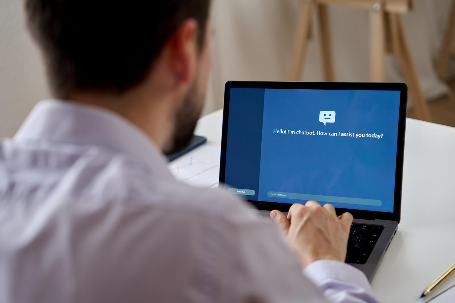 Unrecognizable man talking to a virtual chat assistant