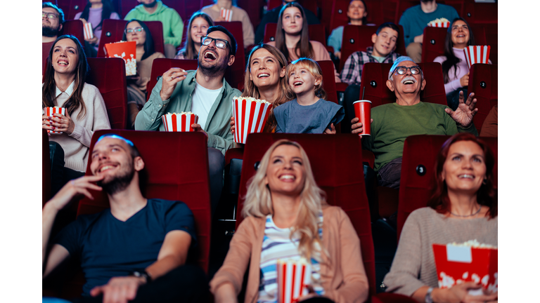 Cheerful family in movie theater.