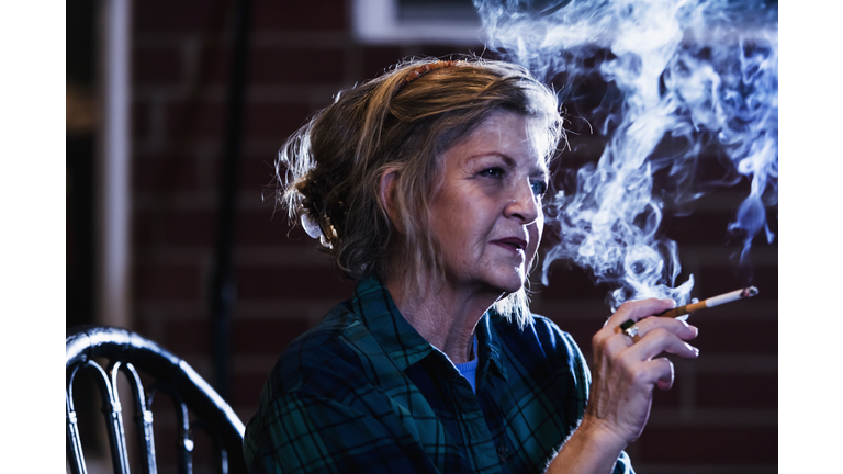 Senior woman smoking a cigarette