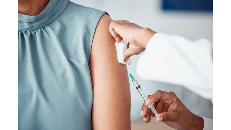 Hands, medical and doctor with patient for vaccine in a clinic for healthcare treatment for prevention. Closeup of a nurse doing a vaccination injection with a needle syringe in a medicare hospital.