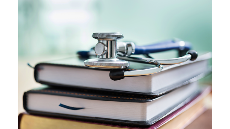 Medical stethoscope on top of books