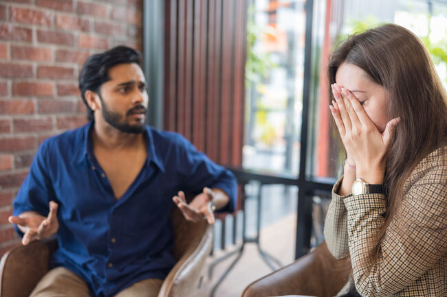 Young couple arguing while having problems in their relationship.