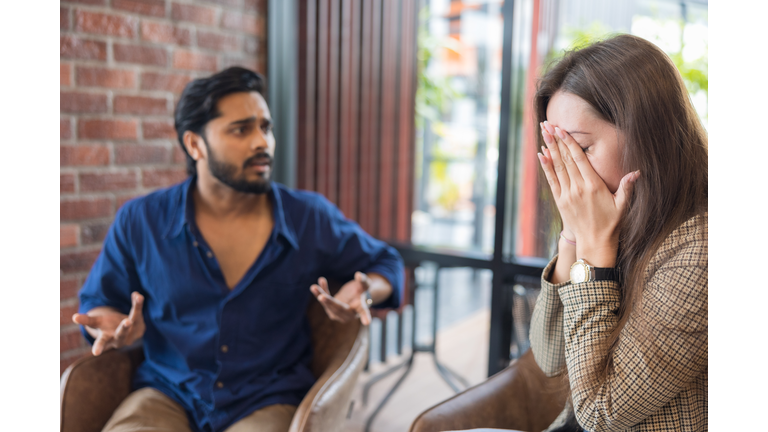 Young couple arguing while having problems in their relationship.