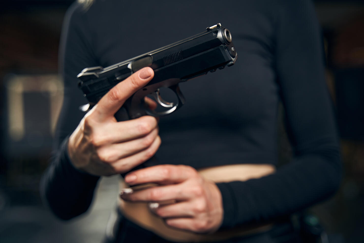 Female preparing for a shooting drill indoors