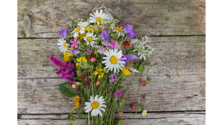 Bouquet of wild flowers on wooden table