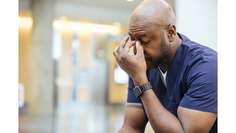 Tired male nurse resting in hospital